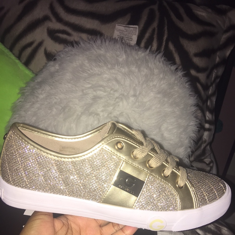 Sparkly gold Guess sneakers.
